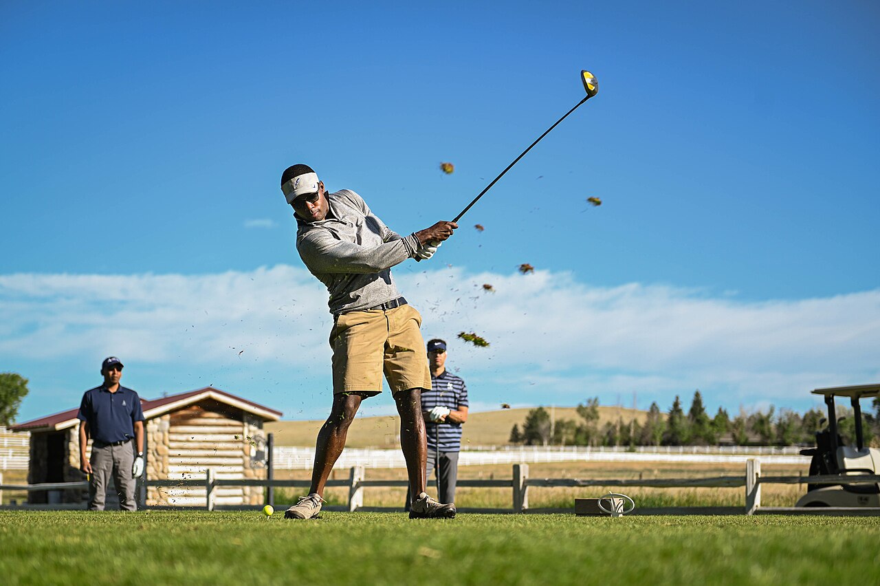 Golfer taking a full swing on the course